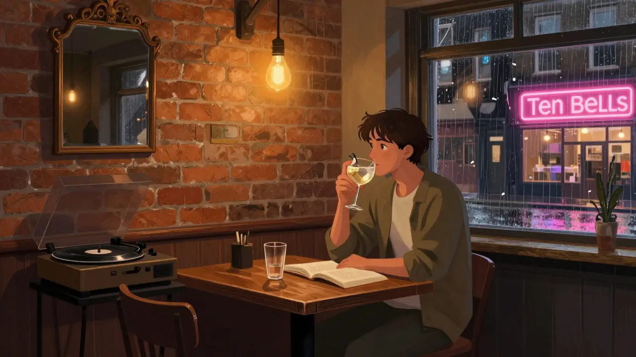 A quiet moment in Shoreditch: someone reads beside a gin cocktail in a historic pub.