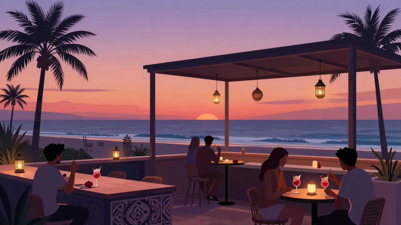 Guests sipping floral cocktails at a beachside rooftop bar as the sun sets over Abu Dhabi.